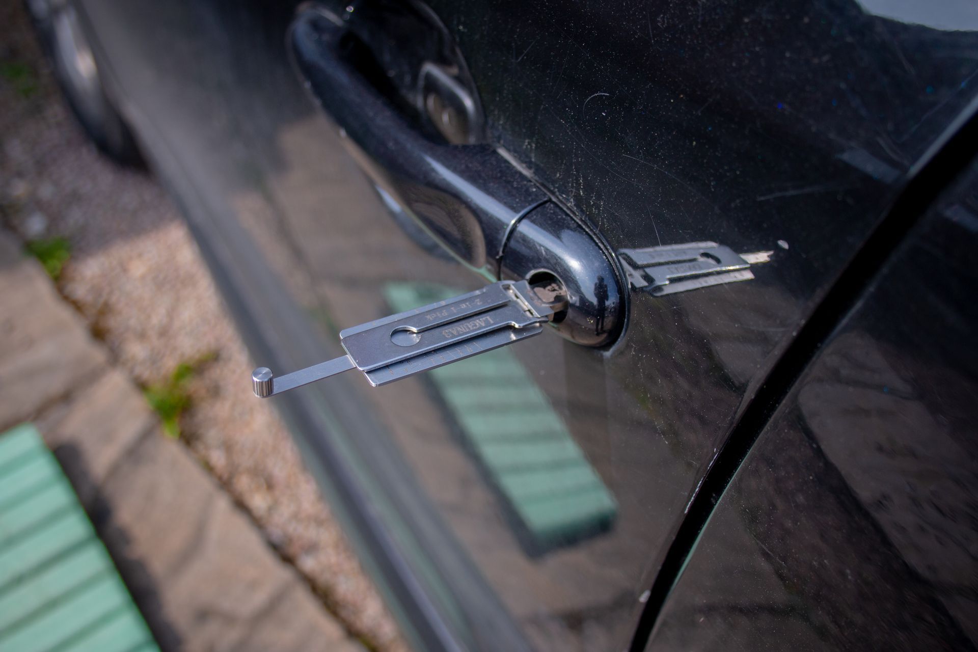 Locksmith tool opening a car door lock